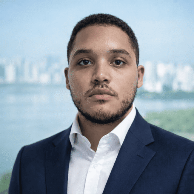 Legal team member at Gomez Tomiczek in Panama wearing formal suit, professional corporate headshot